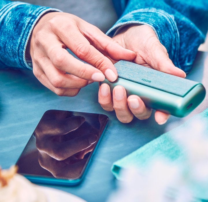 A man using an IQOS device.